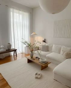 a living room filled with furniture and white walls