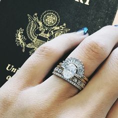 a close up of a person's hand with a passport and ring on it