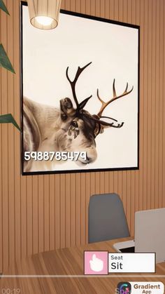 a computer desk with a laptop on it and a deer head mounted to the wall