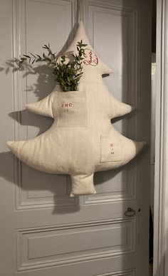 a christmas tree shaped pillow hanging on a door