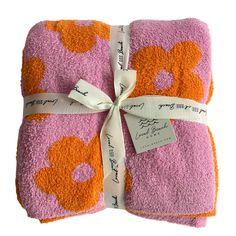 two towels wrapped in pink and orange designs