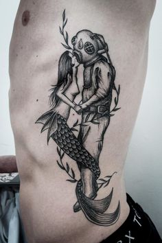 a man with a skull on his back holding a fish and hugging it's face