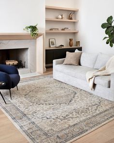 a living room filled with furniture and a fire place in the middle of the room