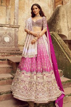 Magenta silk lehenga with heavy embroidery in pearl, cutdana and sequin and attached cancan. Paired with an embroidered padded blouse, a light purple heavily embroidered dupatta with tassels and a magenta embroidered dupatta with a delicate border.
Components: 4
Pattern: Embroidered
Type Of Work: Cutdana, Pearl, Tikki
Neckline: Sweetheart
Sleeve Type: Elbow
Fabric: Silk, Organza
Color: Magenta
Other Details: 
Attached lining
Padded blouse
Approx. product weight: 5 kgs
Lehenga length: 44 inches
O Festive Art Silk Lehenga With Intricate Embroidery, Meenakari Saree Set For Reception, Navratri Meenakari Dola Silk Sets, Bollywood Style Banarasi Silk Lehenga With Intricate Embroidery, Anarkali Lehenga With Intricate Embroidery In Banarasi Silk, Banarasi Silk Lehenga With Intricate Embroidery For Navratri, Navratri Banarasi Silk Lehenga With Intricate Embroidery, Navratri Art Silk Lehenga With Intricate Embroidery, Navratri Art Silk Sets With Intricate Embroidery