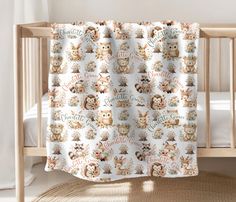 a baby crib with a teddy bear blanket on it