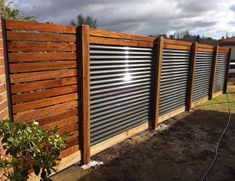 a wooden fence with metal slats on it