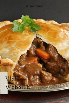 a beef pot pie on a plate with a piece cut out to show it's filling