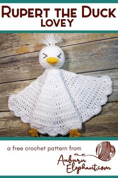 a white crocheted duck with yellow beak