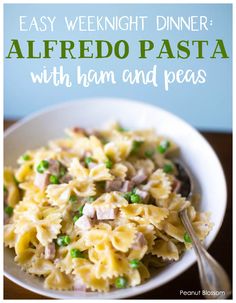 a white bowl filled with pasta and peas