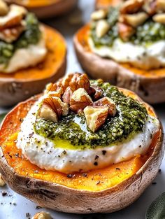 baked sweet potatoes topped with pesto and nuts