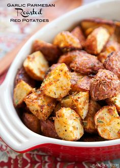 garlic parmesan roasted red potatoes in a white bowl on a colorful tablecloth