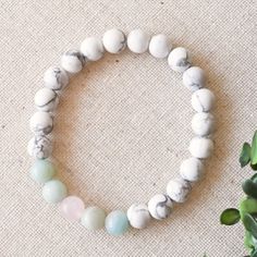 Release, breathe and smile as you wear this calming unicorn crystal bracelet. This healing crystal bracelet integrates white howlite, amazonite, and rose quartz to increase your own calming, self-love vibes while also increasing your mindfulness to maintain this state. We handcraft each natural crystal bracelet using a meditative mala design to let you chill and play with the beads as you wear your special bracelet. The calming unicorn bracelet is completed with reiki vibes and tons of care to h White Amazonite Bracelets With Natural Stones, White Amazonite Bracelet With Natural Stones, Adjustable White Rose Quartz Beaded Bracelets, Adjustable White Rose Quartz Crystal Bracelet, White Rose Quartz Jewelry With 8mm Beads, White Rose Quartz Bracelets With 8mm Beads, White Rose Quartz Beaded Bracelets For Healing, White Rose Quartz Healing Beaded Bracelets, Unicorn Bracelet