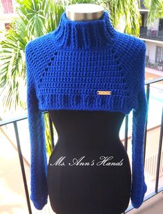 a mannequin wearing a blue knitted sweater