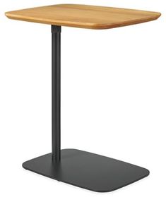 a square wooden table with a black metal base and an oak top, viewed from the front