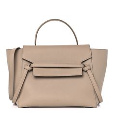 This is an authentic CELINE Grained Calfskin Mini Belt Bag in Dune. This chic handbag is crafted of rich grained calfskin leather in beige with a structured and spacious silhouette. This bag features a looping leather top handle strap, an optional shoulder strap, and aged gold hardware. The facing flap opens to a matching suede interior with hanging patch pockets. Mini Belt Bag, Chic Handbags, Leather Top, Belt Bag, Gold Hardware, Patch Pocket, Top Handle, Calf Skin, Shoulder Strap