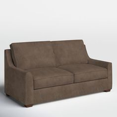 a brown couch sitting on top of a white floor