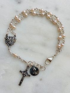 "Beautiful handmade 4mm freshwater potato pearl rosary bracelet.  All beads are wire-wrapped with 22 gauge sterling silver wire and all other metal parts and medals are sterling silver. The connector is a \"Marion Auspice\" which means \"Under the protection of Mary\"" Rosary Ideas, Pearl Rosary, Rosary Bracelet, Silver Wire, Rosary, Sterling Silber, Wire Wrapped, Jewelry Bracelets, Etsy Accessories