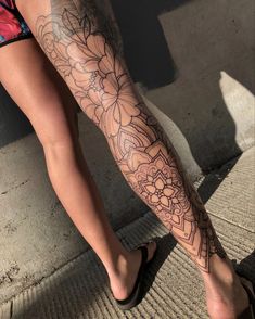 a woman's legs with tattoos on them