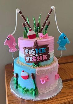 a three tiered cake decorated with pink and blue frosting