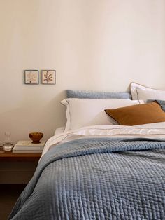 a bed with blue and white bedspread in a bedroom