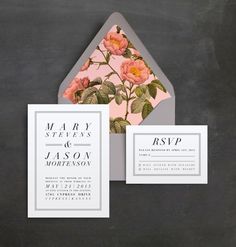 the wedding stationery is displayed in front of an envelope with pink flowers on it