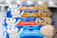 three bars of chocolate chip cookies are lined up on a counter with white and blue icing