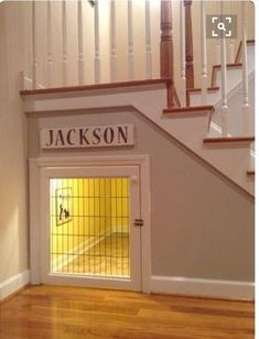 the door is open in front of the staircase and has a sign that says jackson on it