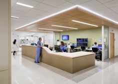 an office with people working at desks and monitors