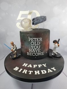 a 50th birthday cake with figurines on it