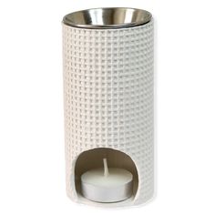 a white candle holder with a metal lid