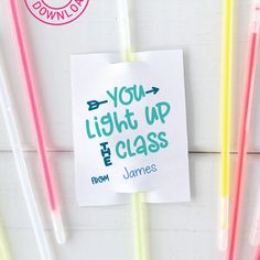 a note that says you light up the class with colored straws next to it