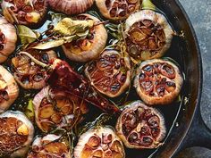 an iron skillet filled with cooked mushrooms and onions