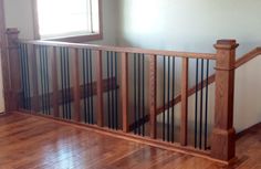 an empty room with hard wood floors and railings on the wall, along with a window