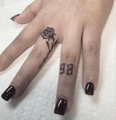 a woman's hand with a rose tattoo on it and the word love written in black ink