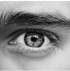 a man's eye is shown in black and white