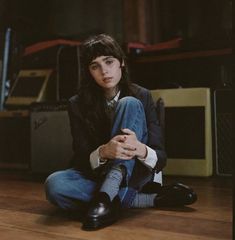 a woman sitting on the floor with her legs crossed