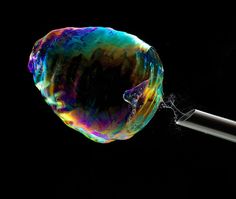 an image of a colorful object being blown by a blow - dryer on a black background