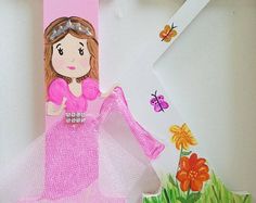 a paper cut out of a girl in a pink dress