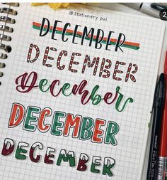 a notebook with some writing on it and two red pens next to the page that says december, december, december, december