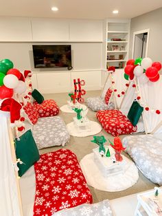 a living room decorated for christmas with red, white and green decorations