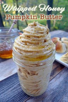 whipped honey pumpkin butter in a mason jar on a picnic table with apples and cookies