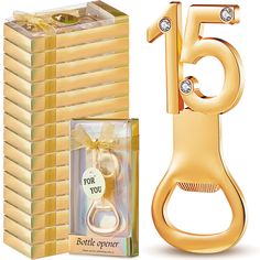 a gold bottle opener with the number fifteen for you next to it and its box