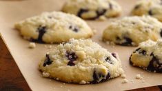 chocolate chip cookies sitting on top of a piece of parchment paper