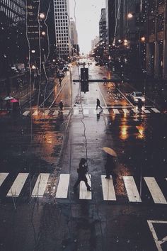 a person walking across a street in the rain with an umbrella over their head and a quote above it