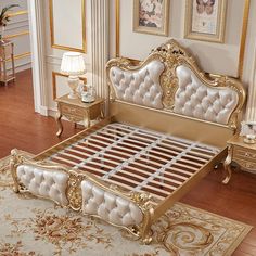 an ornate gold and white bed in a room