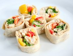 a white plate topped with rolls covered in veggies