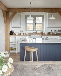 a kitchen with an island and stools in it