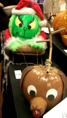 two pumpkins with faces on them sitting on a table