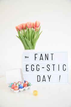 an egg - stic day sign and flowers in a vase with candy candies