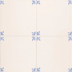 four white tiles with blue designs on them